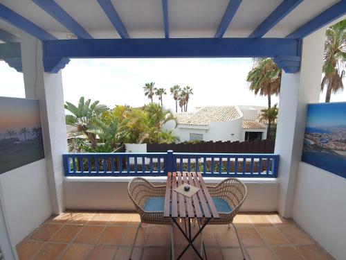 a porch with two chairs and a table on a balcony at Chayofa Blue in Chayofa