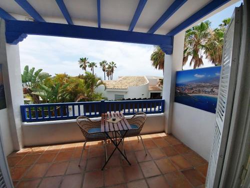 a patio with a table and chairs on a balcony at Chayofa Blue in Chayofa