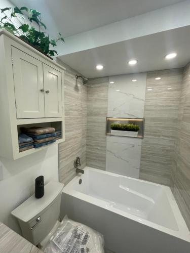 a white bathroom with a tub and a sink at Lake Michigan Retreat in Racine