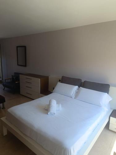 a large white bed with a stuffed animal on it at ATICO DELUXE JACUZZI La Cala BENIDORM in Benidorm