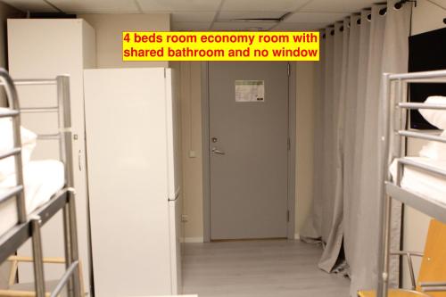 a room with a hallway with a shared bathroom and no window at Hotell Bromma in Stockholm