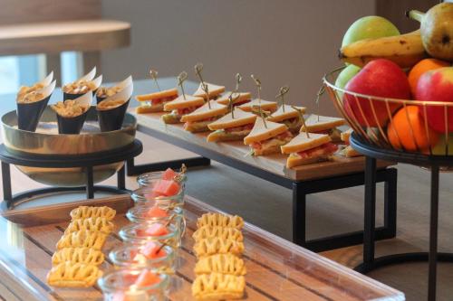 a buffet with cheese and crackers and fruit on a table at Crowne Plaza Utrecht - Central Station by IHG in Utrecht