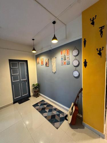 a room with a door and a checkered floor at Palm Nest Villa in Nāgaonkhar