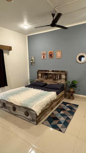 a bedroom with a large wooden bed in a room at Palm Nest Villa in Nāgaonkhar