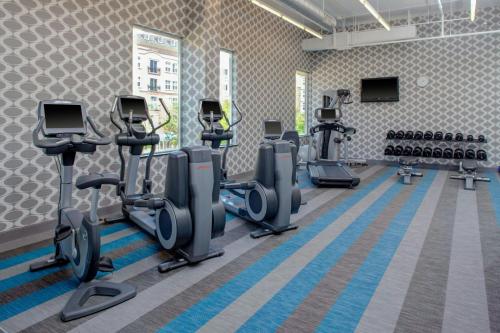 a gym with several treadmills and cardio machines at Aloft Richmond West Short Pump in Short Pump