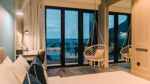 a hotel room with a hammock in a room at H Hotel El Nido - Vegan Friendly Hotel Managed by H Hospitality Group in El Nido