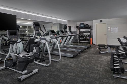 a gym with several treadmills and cardio machines at Fairfield Inn & Suites by Marriott Washington Downtown in Washington