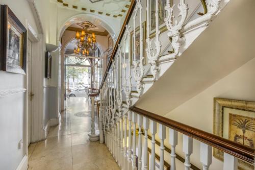a staircase in a home with a chandelier at Opulence Boutique Hotel in London
