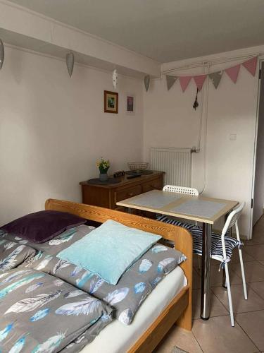 a bedroom with a bed and a table and a desk at Pokoje u Ani i Zbyszka in Wilkasy