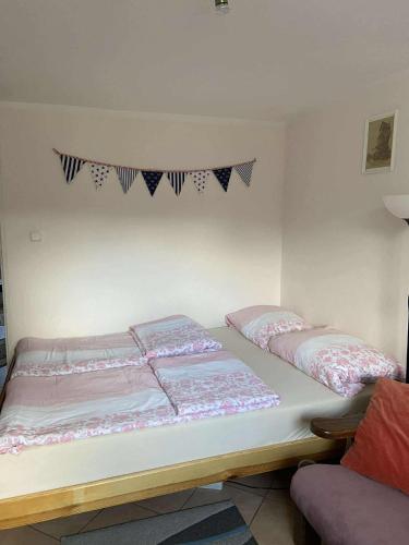 two beds in a room with flags on the wall at Pokoje u Ani i Zbyszka in Wilkasy