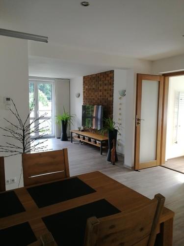 a living room with a table and a couch at Apartmán Červený Vrch in Děčín