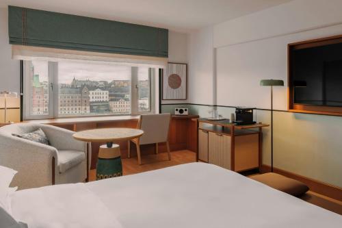 a hotel room with a bed and a television at Sheraton Stockholm Hotel in Stockholm