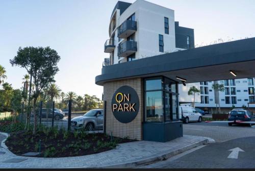 a building with an on park sign in front of a parking lot at ON PARK 317 LUXURY APARTMENT CENTURY CiTY in Century City