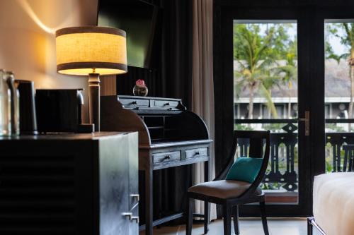 a room with a stove and a table and a chair at Shinta Mani Angkor in Siem Reap