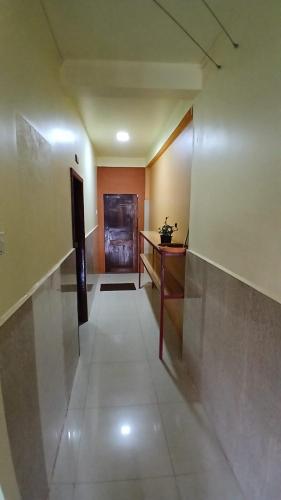 an empty hallway with a table and a desk at Route 76 Guest House in Sen Monorom