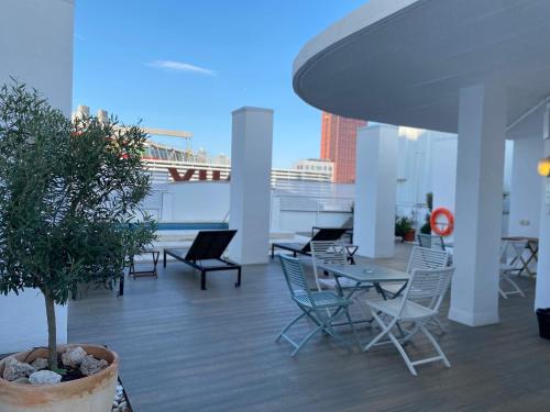 a rooftop patio with chairs and tables on a building at Onix Fira in Barcelona
