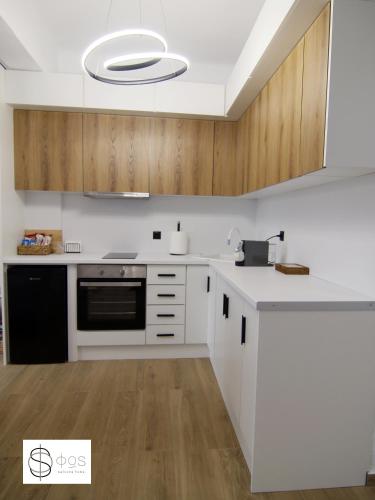 a kitchen with white appliances and wooden cabinets at FOS Kastoria in Kastoria
