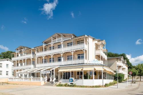 a large white building on the corner of a street at Hotel Selliner Hof in Ostseebad Sellin