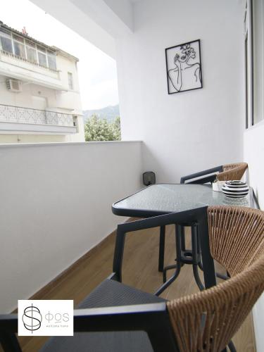 a table and chairs in a room with a window at FOS Kastoria in Kastoria