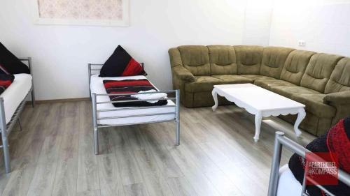 a living room with a couch and a table at Aparthotel Kompass A 201 in Essen