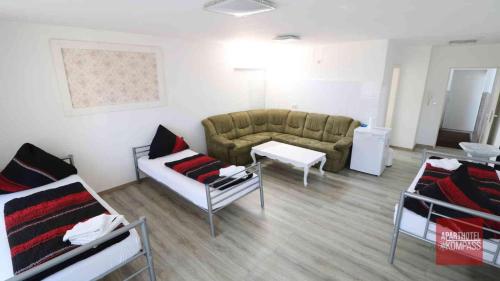 a living room with a couch and a table at Aparthotel Kompass A 201 in Essen