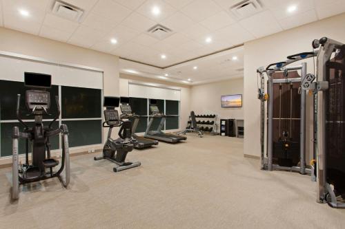 a gym with treadmills and machines in a room at SpringHill Suites by Marriott Huntington Beach Orange County in Huntington Beach