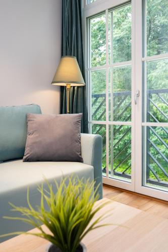 a living room with a couch and a window at Brand new Kalma Apartments in Tallinn