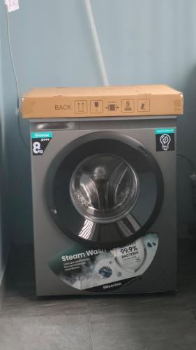 a washing machine with a box on top of it at Keev Homes 2 bedroom Apartment in Port Harcourt