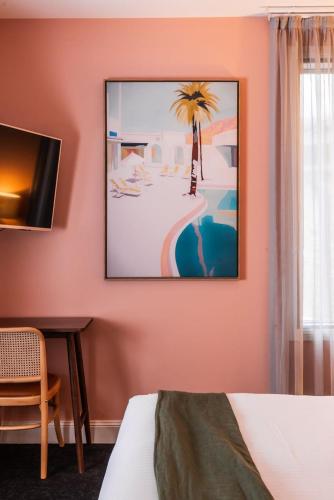 a room with a bed and a picture on the wall at The Lucky Hotel in Newcastle