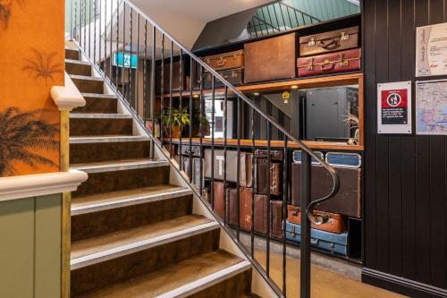 a spiral staircase with books in a library at The Lucky Hotel in Newcastle