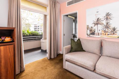 a living room with a couch and a window at The Lucky Hotel in Newcastle