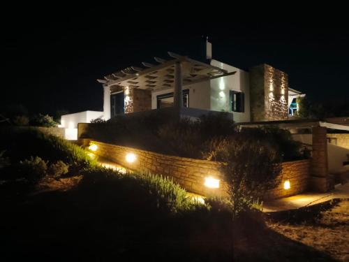 a house with lights in front of it at night at Kedros in Lipsoi