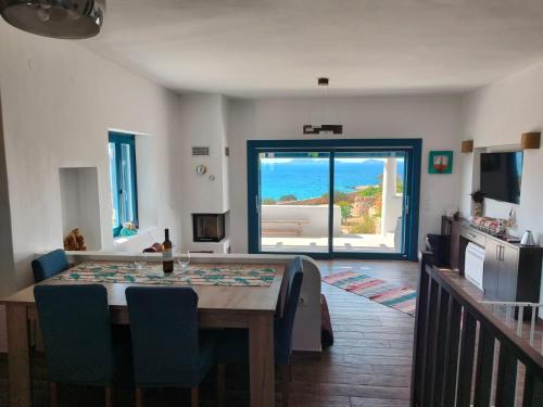 a dining room with a table and a view of the ocean at Kedros in Lipsoi