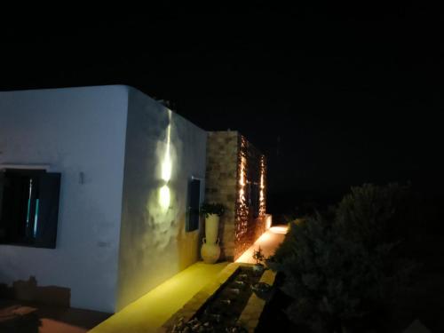 a lit up building at night with a building at Kedros in Lipsoi