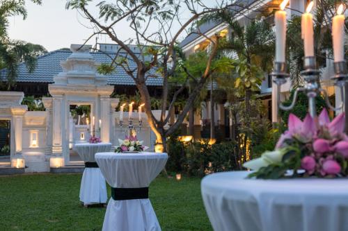 a row of tables in front of a building with flowers at Shinta Mani Angkor in Siem Reap