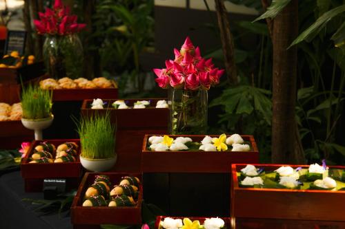 a display of different types of food in boxes with flowers at Shinta Mani Angkor in Siem Reap