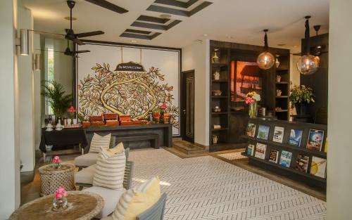 a living room with couches and a fireplace in a store at Shinta Mani Angkor in Siem Reap