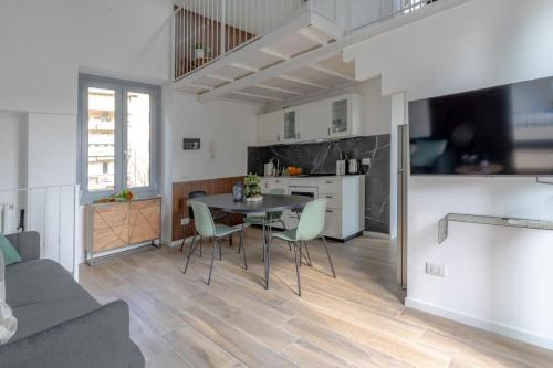 a kitchen and living room with a table and chairs at Green Terrace in Cernobbio center in Cernobbio