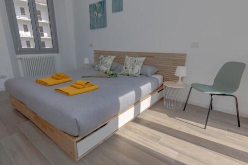 a bedroom with a large bed with yellow towels on it at Green Terrace in Cernobbio center in Cernobbio