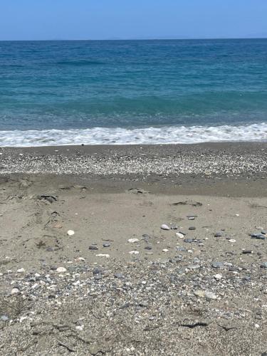 a beach with rocks and the ocean in the background at MOURTERI TASOSEVa in Mourteri