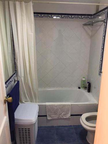 a bathroom with a white tub and a toilet at Confortable Apartment in Corralejo in Corralejo
