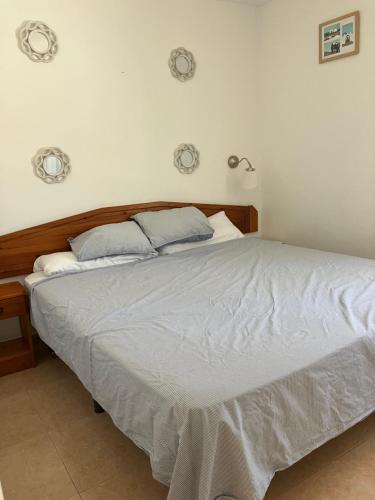 a bedroom with a large bed with white sheets at Confortable Apartment in Corralejo in Corralejo