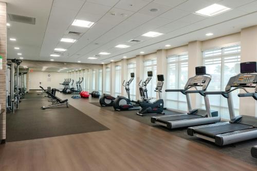 a gym with treadmills and elliptical machines at Courtyard by Marriott Savannah Airport in Savannah