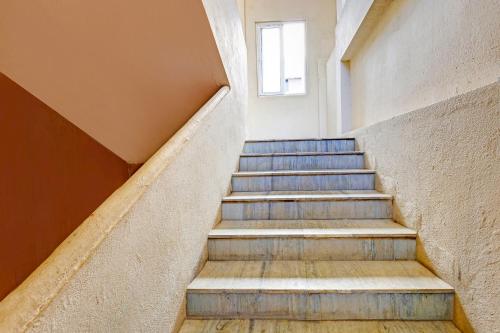 a set of stairs in a building with a window at FabHotel Siddarth in Vijayawāda