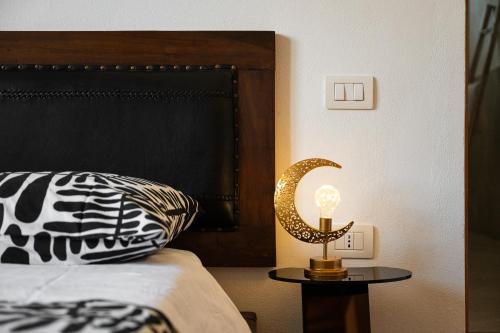 a bedroom with a bed and a candle on a table at Villa Pilato in Poggio Dei Pini