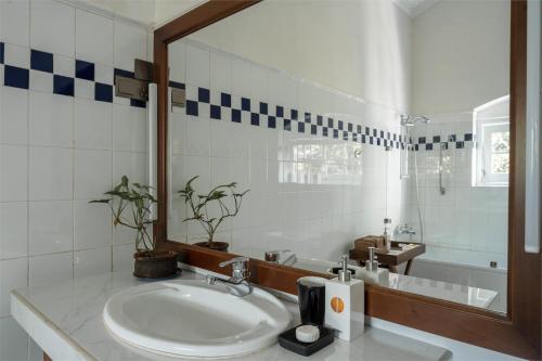 a bathroom with a sink and a mirror and a tub at Glenross Living - A Collection of 7 Private Pool Villas and 3 Colonial Suites in Kalutara