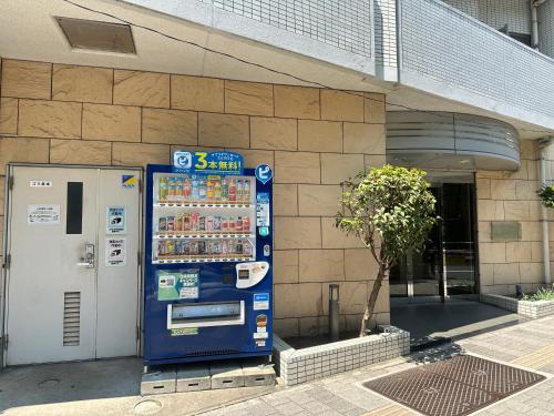 a vending machine sitting in front of a building at Sunshine Grand Hotel Ikebukuro in Tokyo