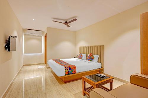 a hotel room with a bed and a couch at FabHotel Siddarth in Vijayawāda