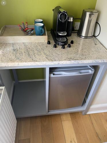 a kitchen counter with a sink and a coffee maker at Rooms near Weston-super-Mare in Uphill