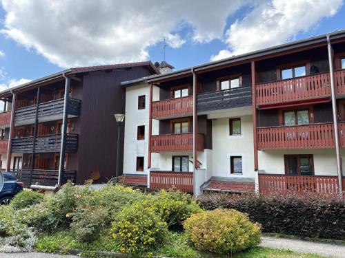 an apartment building with red balconies on it at Appartement Duplex in Habère-Poche
